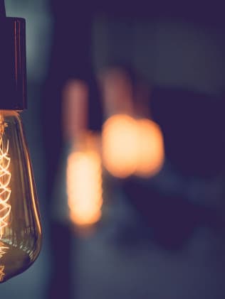 Vintage Edison light bulbs glowing in a dark room